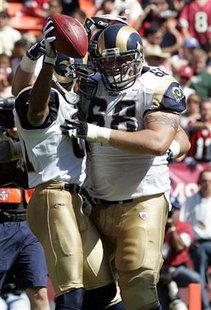 
St. Louis Rams wide receiver Torry Holt (L) is congratulated by teammate Richie Incognito after catching a touchdown pass in the second quarter of their NFL football game against the San Francisco 49ers in San Francisco, California, September 17, 2006. REUTERS/Kimberly White
