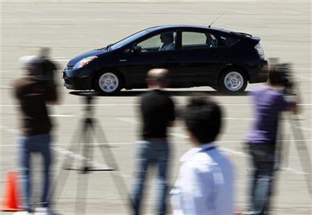 
Members of the media record and watch as a 2008 Toyota Prius is demonstrated breaking at 85 MPH in a stadium parking lot following Toyota's announcement of preliminary findings regarding their investigation of the unintended acceleration incident involving a 2008 Toyota Prius at a news conference in San Diego, California March 15, 2010. REUTERS/Mike Blake
