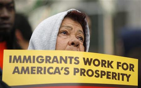 
A demonstrator holds a sign while taking part in a rally in front of the Department of Homeland Security in Washington January 26, 2010. REUTERS/Molly Riley
