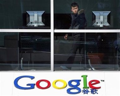 
A man looks at a computer located in the foyer of the Google headquarters building in Beijing March 17, 2010. REUTERS/David Gray
