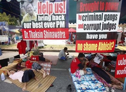 
Supporters of former Prime Minister Thaksin Shinawatra rest during a rally in Bangkok March 19, 2010. REUTERS/Chaiwat Subprasom
