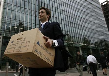 
A worker carries a box out of the U.S. investment bank Lehman Brothers offices in the Canary Wharf district of London in this September 15, 2008 file photo. REUTERS/Andrew Winning
