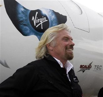 Richard Branson stands beside Virgin Mother Ship Eve, White Knight Two, at Wittman Field, site of the Experimental Aircraft Association Convention in Oshkosh, Wisconsin July 27, 2009. REUTERS/Allen Fredrickson
Richard Branson stands beside Virgin Mother Ship Eve, White Knight Two, at Wittman Field, site of the Experimental Aircraft Association Convention in Oshkosh, Wisconsin July 27, 2009. REUTERS/Allen Fredrickson