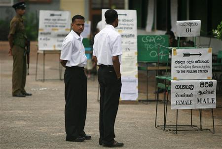 Polling monitors stand ready to help voters at a polling station in Colombo April 8, 2010. REUTERS/Andrew Caballero-Reynolds
Polling monitors stand ready to help voters at a polling station in Colombo April 8, 2010. REUTERS/Andrew Caballero-Reynolds