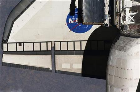 A partial view of the port wing of the space shuttle Discovery is seen in this image taken by an Expedition 23 crew member with a digital still camera, using a 400mm lens at a distance of about 600 feet April 7, 2010. REUTERS/NASA/Handout
A partial view of the port wing of the space shuttle Discovery is seen in this image taken by an Expedition 23 crew member with a digital still camera, using a 400mm lens at a distance of about 600 feet April 7, 2010. REUTERS/NASA/Handout