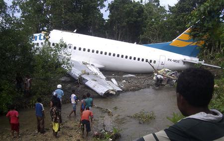People gather to look at a Merpati Boeing 737-300 as it lies skidded off on the runway in Rendani airport in Manokwari of the Indonesia's West Papua province April 13, 2010. REUTERS/Laode Mursidin
People gather to look at a Merpati Boeing 737-300 as it lies skidded off on the runway in Rendani airport in Manokwari of the Indonesia's West Papua province April 13, 2010. REUTERS/Laode Mursidin