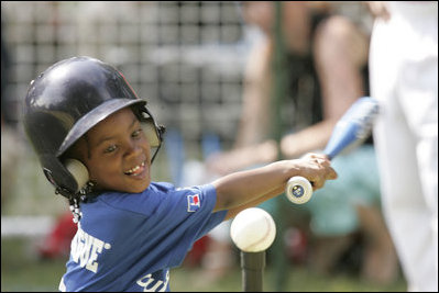 A young child plays in a game of tee-ball A young child plays in a game of tee-ball