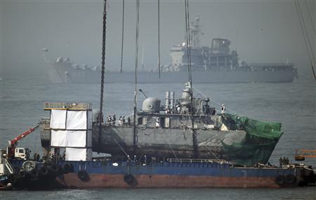The stern of the Navy corvette Cheonan is docked on a barge off Baengnyeongdo island near the maritime border with North Korea, northwest of Seoul April 16, 2010. REUTERS/Lee Jung-Hoon/Yonhap
The stern of the Navy corvette Cheonan is docked on a barge off Baengnyeongdo island near the maritime border with North Korea, northwest of Seoul April 16, 2010. REUTERS/Lee Jung-Hoon/Yonhap