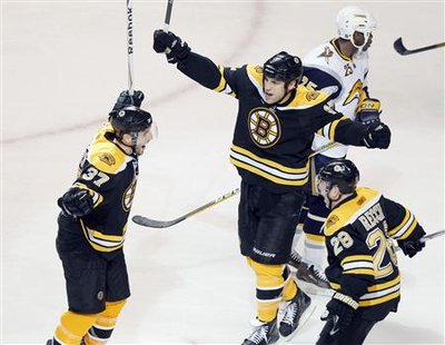 Boston Bruins center Patrice Bergeron (L) celebrates his goal with teammates Milan Lucic and Mark Recchi (R), as Buffalo Sabres right wing Mike Grier skates off, during the third period of Game 3 of their NHL Eastern Conference quarter-final hockey game in Boston, Massachusetts April 19, 2010. REUTERS/Adam Hunger
Boston Bruins center Patrice Bergeron (L) celebrates his goal with teammates Milan Lucic and Mark Recchi (R), as Buffalo Sabres right wing Mike Grier skates off, during the third period of Game 3 of their NHL Eastern Conference quarter-final hockey game in Boston, Massachusetts April 19, 2010. REUTERS/Adam Hunger