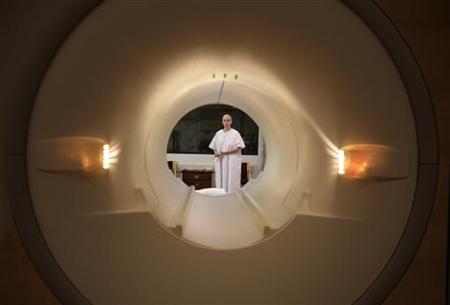 
Cancer patient Deborah Charles is seen through the tube of a magnetic resonance imaging scanner as she prepares to enter the MRI machine for an examination at Georgetown University Hospital in Washington May 23, 2007. REUTERS/Jim Bourg
