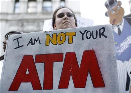 A protester holds a sign during the "Main Street to Wall Street" rally in New York's financial district April 29, 2010. REUTERS/Mike Segar
A protester holds a sign during the "Main Street to Wall Street" rally in New York's financial district April 29, 2010. REUTERS/Mike Segar