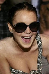 Actress Lindsay Lohan poses for photographers before attending the Roberto Cavalli Fall/Winter 2010/11 Women's collection during Milan Fashion Week February 28, 2010. REUTERS/Alessandro Garofalo
Actress Lindsay Lohan poses for photographers before attending the Roberto Cavalli Fall/Winter 2010/11 Women's collection during Milan Fashion Week February 28, 2010. REUTERS/Alessandro Garofalo