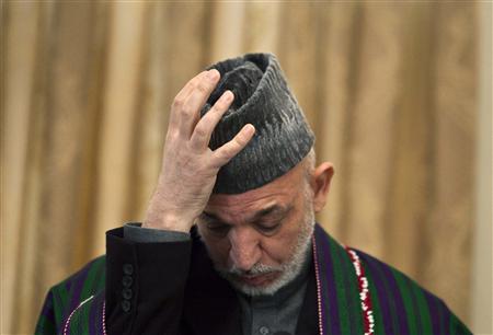 Afghan President Hamid Karzai adjusts his hat during a news conference in Kabul January 31, 2010. REUTERS/Ahmad Masood
Afghan President Hamid Karzai adjusts his hat during a news conference in Kabul January 31, 2010. REUTERS/Ahmad Masood