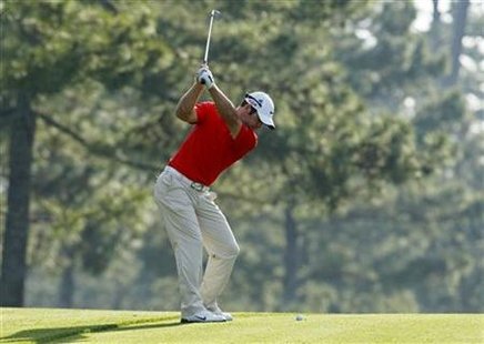 
Paul Casey of England hits his approach shot to the 14th green during a practice round for the 2010 Masters golf tournament at the Augusta National Golf Club in Augusta, Georgia, April 7, 2010. REUTERS/Shaun Best
