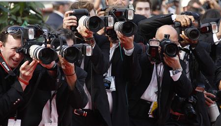 
Press photographers take pictures of guest walking on the red carpet ahead of the screening of the film Poetry in competition at the 63rd Cannes Film Festival, May 19, 2010. REUTERS/Yves Herman
