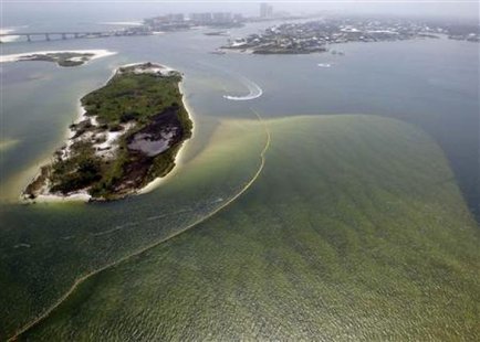 A protective boom is strung through the waters of Perdido Pass, Alabama, May 11, 2010.
(Credit: REUTERS/Brian Snyder)
