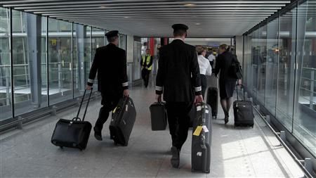
British Airways aircrew carry baggage at Terminal 5 in Heathrow Airport, west of London May 25, 2010. More flights in and out of Heathrow were cancelled on Tuesday as industrial action by British Airways cabin crew continued for a second day. REUTERS/Eddie Keogh
