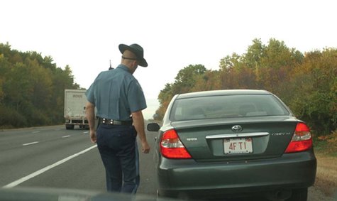 A police officer making a traffic stop. A police officer making a traffic stop.