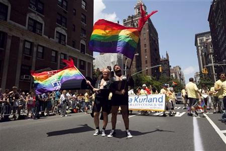 Men dressed in tuxedo jackets to emulate grooms at a wedding wave flags touting their 30 years in a relationship together as a form of support for gay marriage, in the annual Gay Pride Parade in New York June 28, 2009. REUTERS/Jacob Silberberg
Men dressed in tuxedo jackets to emulate grooms at a wedding wave flags touting their 30 years in a relationship together as a form of support for gay marriage, in the annual Gay Pride Parade in New York June 28, 2009. REUTERS/Jacob Silberberg