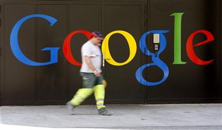 
A construction worker walks past a logo next to the main entrance of the Google building in Zurich May 25, 2010. REUTERS/Arnd Wiegmann
