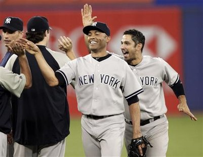 New York Yankees pitchers Mariano Rivera (2nd R) and Jorge Posada (R) celebrate their win against the Toronto Blue Jays with their team-mates during the ninth inning of their MLB American League baseball game in Toronto June 6, 2010. REUTERS/ Mike Cassese
New York Yankees pitchers Mariano Rivera (2nd R) and Jorge Posada (R) celebrate their win against the Toronto Blue Jays with their team-mates during the ninth inning of their MLB American League baseball game in Toronto June 6, 2010. REUTERS/ Mike Cassese