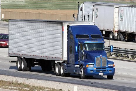 A tractor trailer on a highway. A tractor trailer on a highway.