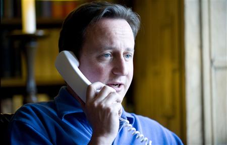 Britain's Prime Minister David Cameron talks to U.S. President Barack Obama on the phone in his office at his official country residence of Chequers outside London June 12, 2010. REUTERS/Andrew Parsons/handout
Britain's Prime Minister David Cameron talks to U.S. President Barack Obama on the phone in his office at his official country residence of Chequers outside London June 12, 2010. REUTERS/Andrew Parsons/handout