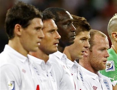 
England's players stand during the national anthem before their 2010 World Cup Group C soccer match against Algeria at Green Point stadium in Cape Town June 18, 2010. Picture taken June 18, 2010. From left are: Gareth Barry, Frank Lampard, Emile Heskey, Steven Gerrard and Wayne Rooney. REUTERS/Eddie Keogh
