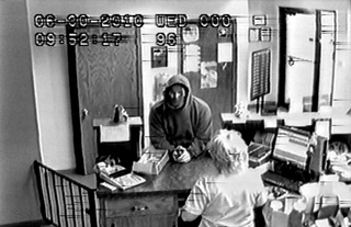 This still frame taken from surveillance video and provided by the Shawano Co. Sheriff's Office shows the man who allegedly robbed the Pineries Bank in Mattoon, June 30, 2010.

