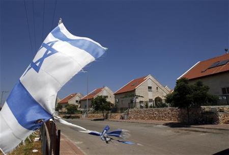 
An Israeli flag waves in the West Bank Jewish settlement of Ofra, near Ramallah, July 5, 2010. REUTERS/Ronen Zvulun
