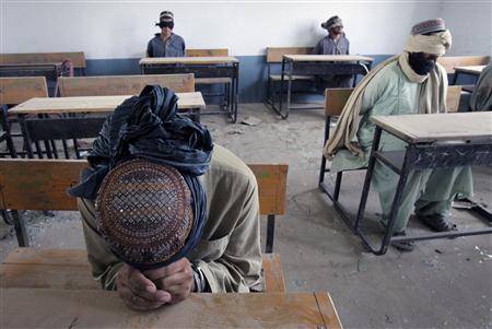 A group of men detained for suspected Taliban activities are held for questioning at a schoolhouse in the village of Kuhak in Arghandab District, north of Kandahar July 9, 2010. REUTERS/Bob Strong
A group of men detained for suspected Taliban activities are held for questioning at a schoolhouse in the village of Kuhak in Arghandab District, north of Kandahar July 9, 2010. REUTERS/Bob Strong