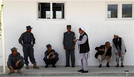 
Afghan national policemen gather in a courtyard near the German Bundeswehr army camp in Kunduz, May 3, 2010. REUTERS/Fabrizio Bensch
