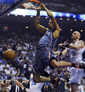 Charlotte Bobcats center Tyson Chandler (L) dunks in front of Orlando Magic center Marcin Gortat (R) during the first half of Game 2 of their NBA Eastern Conference playoff series in Orlando, Florida April 21, 2010. REUTERS/Kevin Kolczynski
Charlotte Bobcats center Tyson Chandler (L) dunks in front of Orlando Magic center Marcin Gortat (R) during the first half of Game 2 of their NBA Eastern Conference playoff series in Orlando, Florida April 21, 2010. REUTERS/Kevin Kolczynski