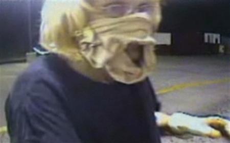 
A video grab shows Sharon Lain, with a woman's girdle wrapped around her face as a make-shift mask, robbing an Oklahoma McDonald's. Lain, 51, an unemployed woman who said she was desperate for money has been arrested on charges she robbed the McDonald's. REUTERS/Midwest City Police Department/Handout
