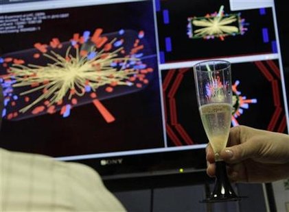 
A scientist holds a glass of champagne after the first successful collisions at full power at the Compact Muon Solenoid (CMS) experience control room at the Large European Organisation for Nuclear Research (CERN) in Meyrin, near Geneva, March 30, 2010. REUTERS/Denis Balibouse
