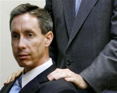 Defense attorney Walter F. Bugden stands with his hands on Warren Jeffs' shoulders as he presents closing arguments in Jeffs' trial in St. George, Utah, September 21, 2007. REUTERS/Trent Nelson/Pool
Defense attorney Walter F. Bugden stands with his hands on Warren Jeffs' shoulders as he presents closing arguments in Jeffs' trial in St. George, Utah, September 21, 2007. REUTERS/Trent Nelson/Pool