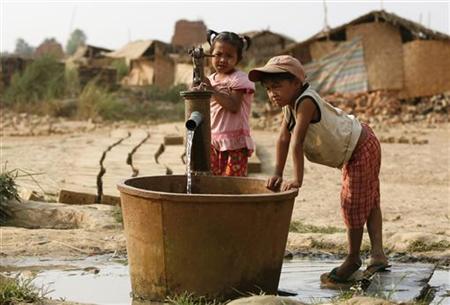 
A girl and a boy collect water at a well at a brick kiln near Hlawga village, 22 miles (35 km) north of Yangon April 20, 2010. REUTERS/Soe Zeya Tun
