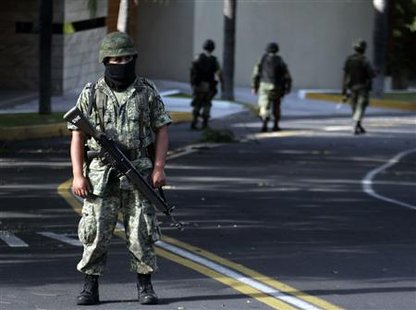 
Mexican soldiers stand guard on a street in Guadalajara City, Mexico July 29, 2010. REUTERS/Alejandro Acosta
