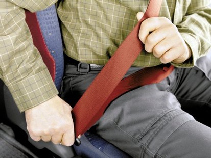 A man putting on his seatbelt.