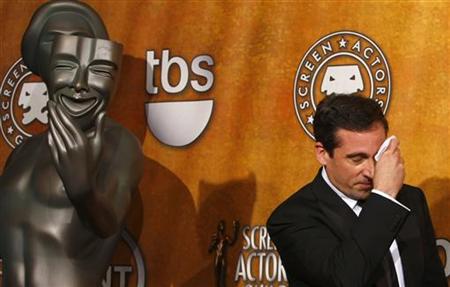 
Actor Steve Carrell mops his brow while he holds his award for best ensemble comedy for "The Office'' while backstage at the 14th annual Screen Actors Guild Awards in Los Angeles January 27, 2008. REUTERS/Mike Blake
