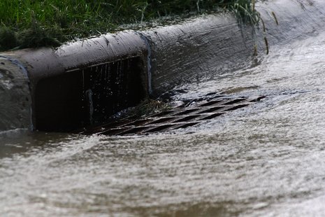 An overflowing storm drain.