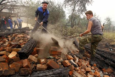 
Rescue personnel remove the debris of a burnt out house in the village of Borkovka, outside the town of Vyksa, some 150 km (93 miles) southwest of the Volga city of Nizhny Novgorod, July 31, 2010. Raging wildfires spread across parts of western Russia on Saturday, engulfing 30 percent more land in just 24 hours, and Prime Minister Vladimir Putin described the situation as very difficult. REUTERS/Mikhail Voskresensky
