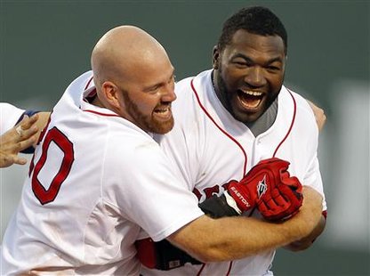 Boston Red Sox designated hitter David Ortiz (R) is congratulated by teammate Kevin Youkilis after hitting the game-winning 3-RBI double to beat the Detroit Tigers during the ninth inning of their MLB American League baseball game at Fenway Park in Boston, Massachusetts July 31, 2010. REUTERS/Adam Hunger
Boston Red Sox designated hitter David Ortiz (R) is congratulated by teammate Kevin Youkilis after hitting the game-winning 3-RBI double to beat the Detroit Tigers during the ninth inning of their MLB American League baseball game at Fenway Park in Boston, Massachusetts July 31, 2010. REUTERS/Adam Hunger