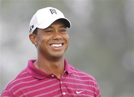 
Tiger Woods smiles as he waits to hit on the sixth hole during a practice round for the 92nd PGA Golf Championship at Whistling Straits in Haven, Wisconsin, August 10, 2010. REUTERS/Mathieu Belanger
