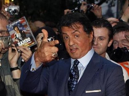 
U.S. actor Sylvester Stallone poses with fans as he arrives for the German premiere of his new movie "The Expendables" in Berlin, August 6, 2010. REUTERS/Thomas Peter
