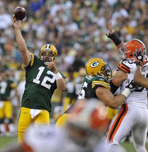 Green Bay Packers' Aaron Rodgers (12) tosses a touchdown pass against the Cleveland Browns during the first half of a preseason NFL football game Saturday, Aug. 14, 2010, in Green Bay, Wis. (AP Photo/Jim Prisching) Green Bay Packers' Aaron Rodgers (12) tosses a touchdown pass against the Cleveland Browns during the first half of a preseason NFL football game Saturday, Aug. 14, 2010, in Green Bay, Wis. (AP Photo/Jim Prisching)