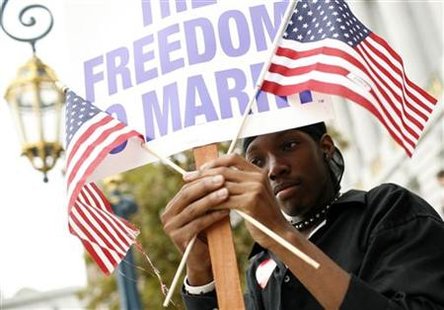 Same sex marriage supporter Dominic Coluans waves flags outside City Hall after a judge lifted the Proposition 8 stay on same sex marriages at City Hall in San Francisco, California August 12, 2010. REUTERS/Robert Galbraith
Same sex marriage supporter Dominic Coluans waves flags outside City Hall after a judge lifted the Proposition 8 stay on same sex marriages at City Hall in San Francisco, California August 12, 2010. REUTERS/Robert Galbraith