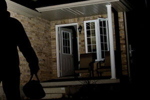 A burglar leaving a house.