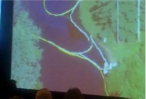 EPA Administrator Susan Hedman shows a slider on the mixture of oil and water in the Kalamazoo river while conducting the Marshall Town Hall Meeting.