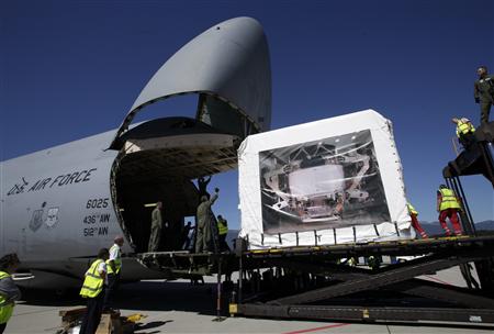 Staff attempt to load the Alpha Magnetic Spectrometer (AMS) detector into a U.S. Air Force Galaxy aircraft during last preparations at Cointrin Airport in Geneva August 25, 2010. REUTERS/Denis Balibouse
Staff attempt to load the Alpha Magnetic Spectrometer (AMS) detector into a U.S. Air Force Galaxy aircraft during last preparations at Cointrin Airport in Geneva August 25, 2010. REUTERS/Denis Balibouse